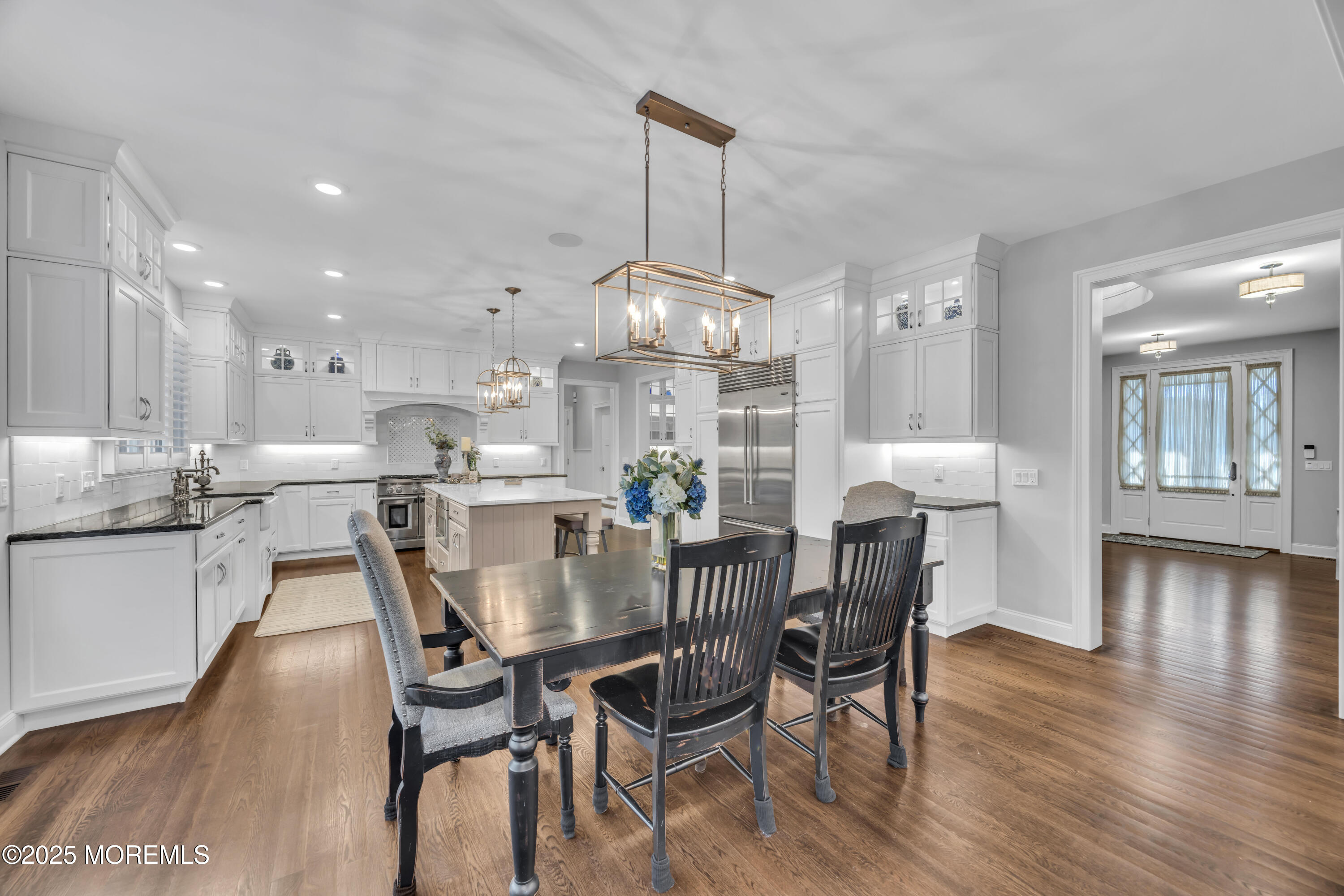 145 Heulitt Road Colts Neck, NJ 07722 - Photo 20 of 59 a kitchen with stainless steel appliances granite countertop a dining table chairs and white cabinets