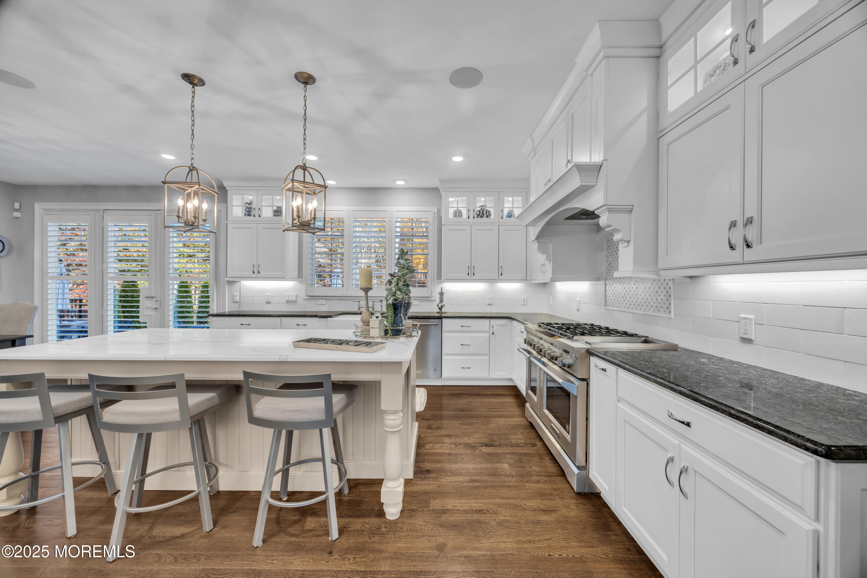 145 Heulitt Road Colts Neck, NJ 07722 - Photo 25 of 59 a kitchen with stainless steel appliances granite countertop a kitchen island a stove a table and chairs in it