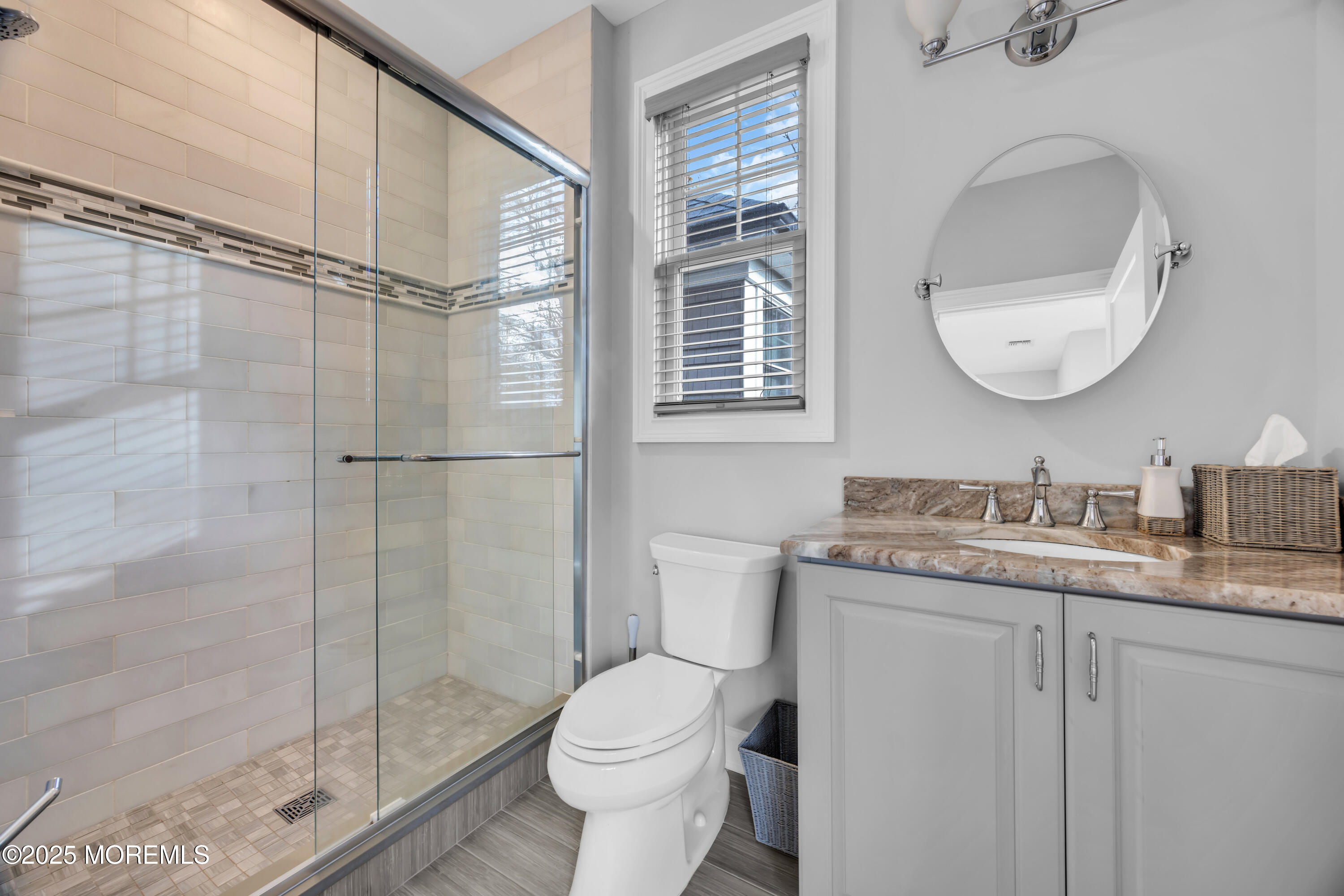 145 Heulitt Road Colts Neck, NJ 07722 - Photo 32 of 59 a bathroom with a granite countertop sink toilet a mirror and shower