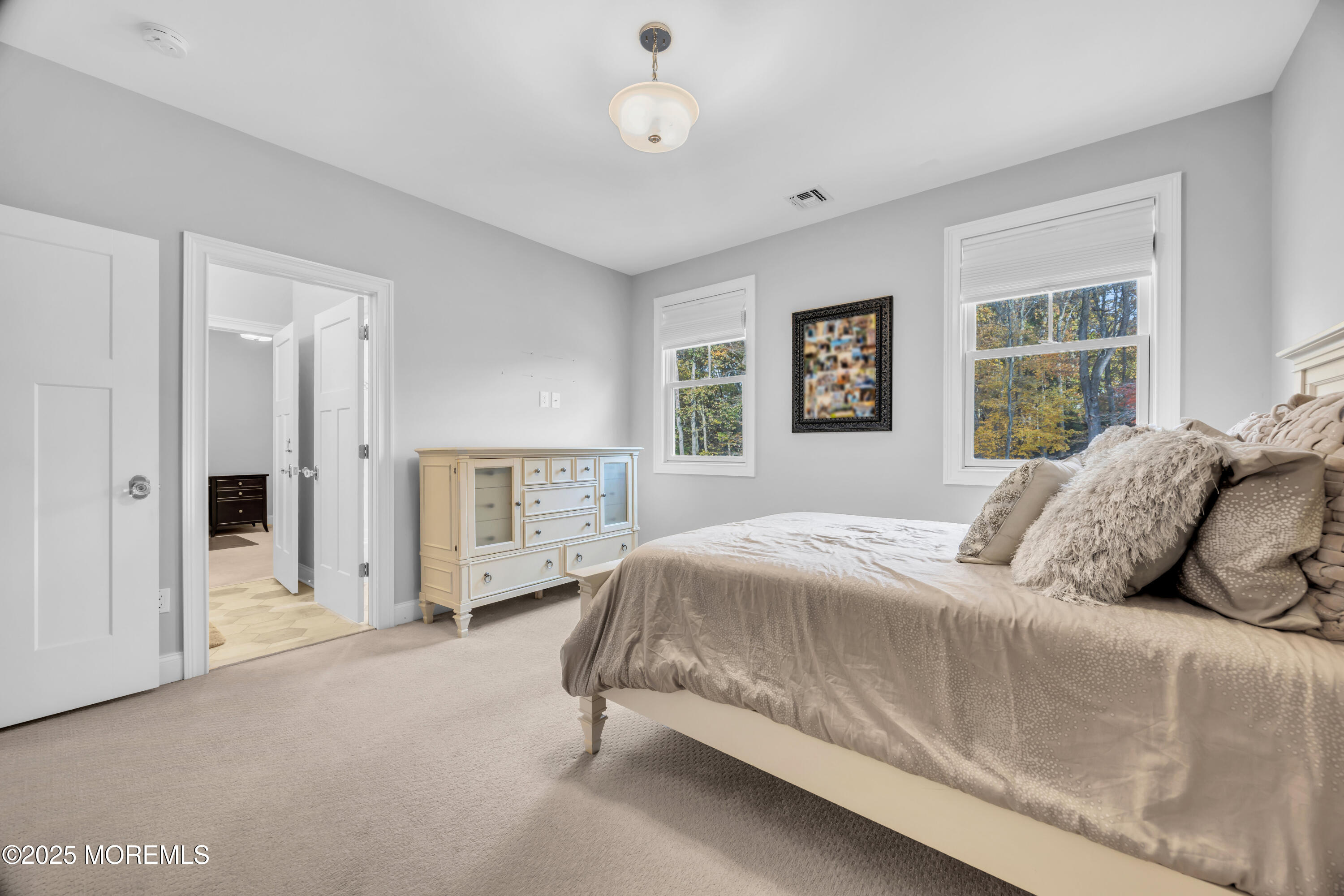 145 Heulitt Road Colts Neck, NJ 07722 - Photo 39 of 59 a bedroom with a large bed and a window