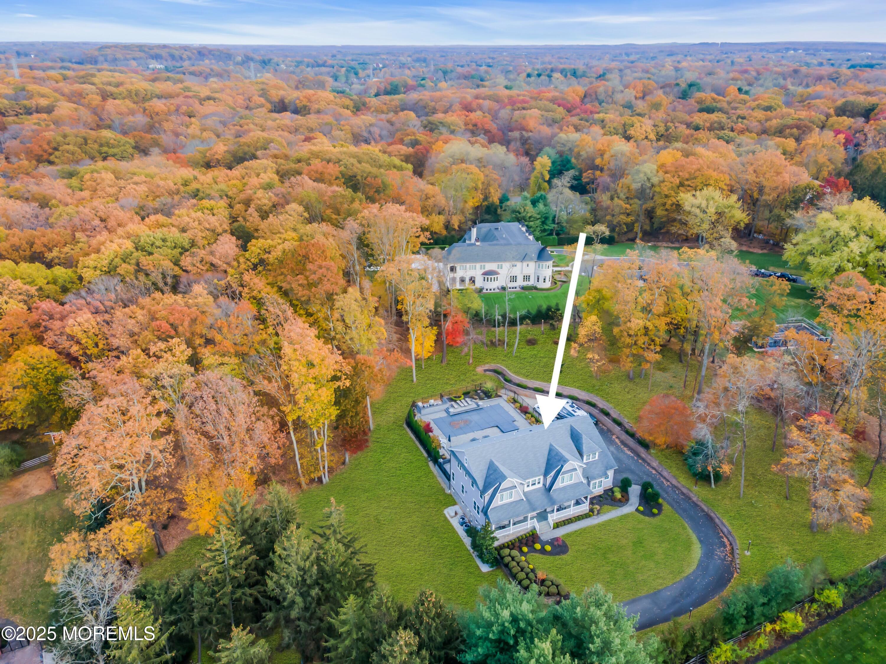 145 Heulitt Road Colts Neck, NJ 07722 - Photo 56 of 59 an aerial view of a house with a garden and lake view
