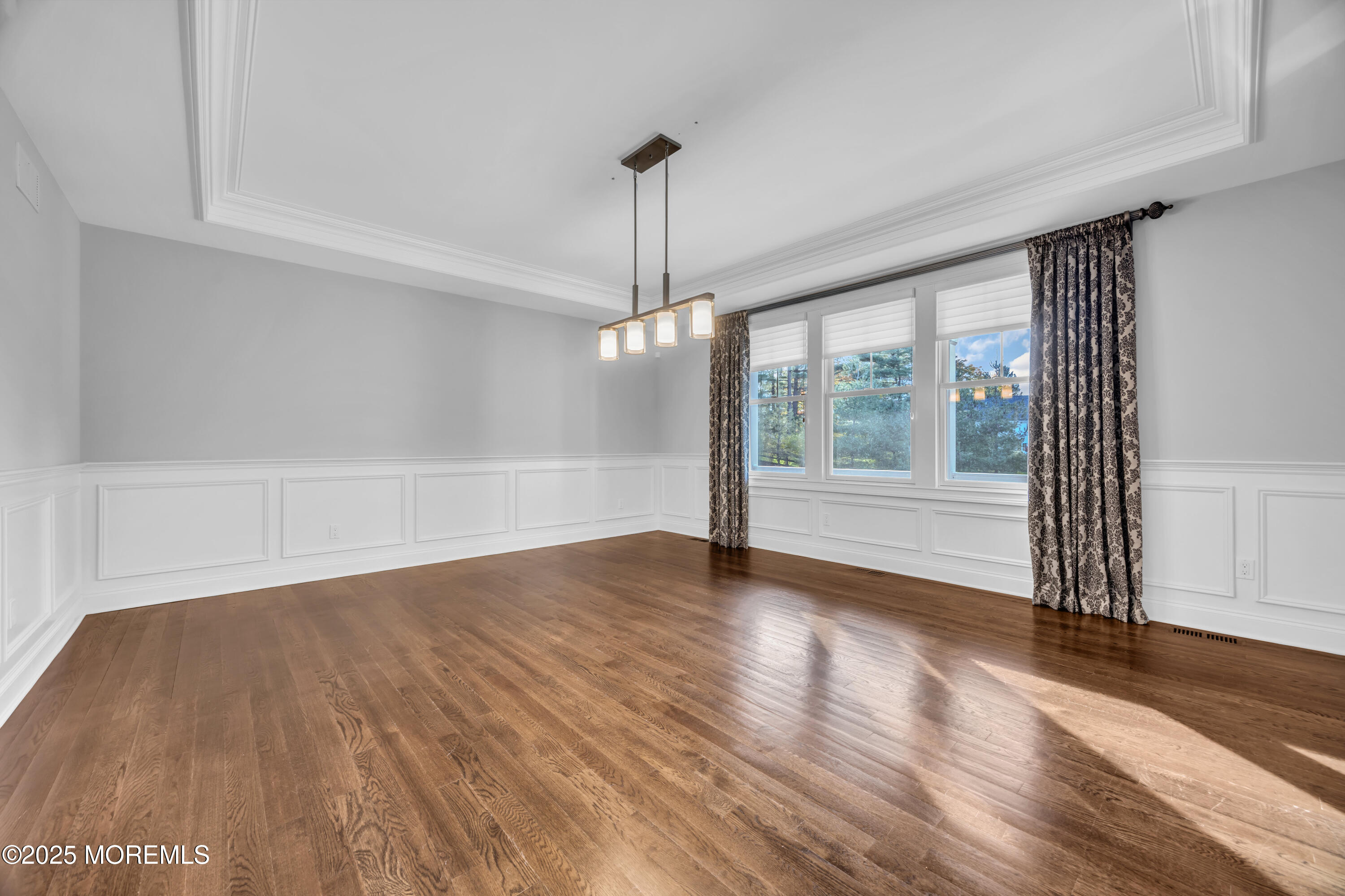 145 Heulitt Road Colts Neck, NJ 07722 - Photo 8 of 59 a view of an empty room with wooden floor and a window