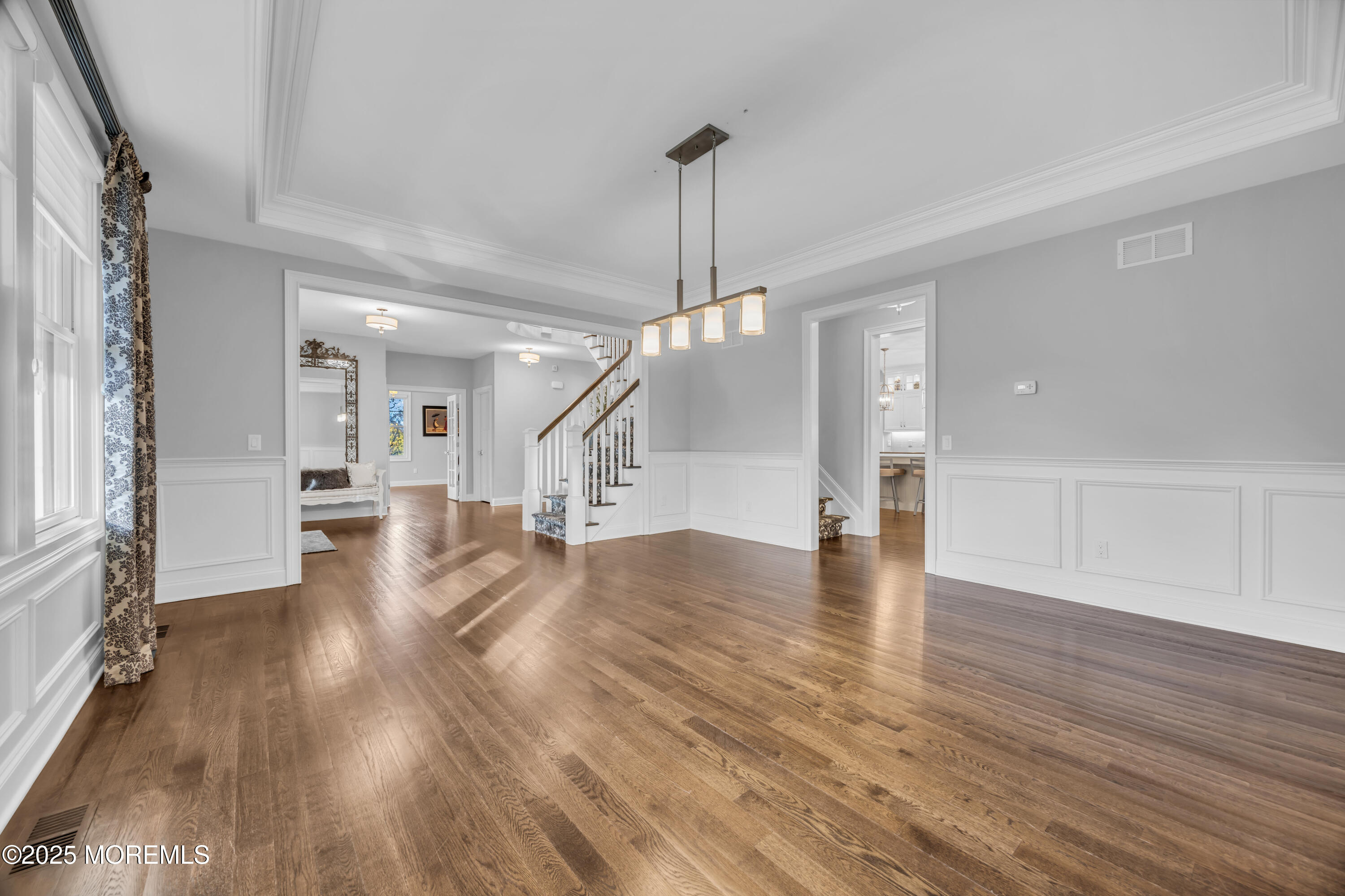 145 Heulitt Road Colts Neck, NJ 07722 - Photo 10 of 59 a view of a hallway with wooden floor windows and a chandelier