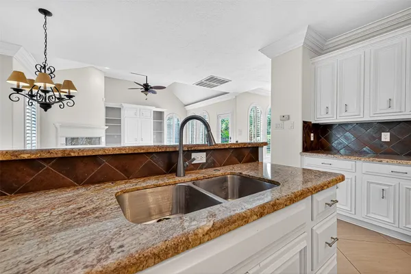 a kitchen with a sink and a stove top oven