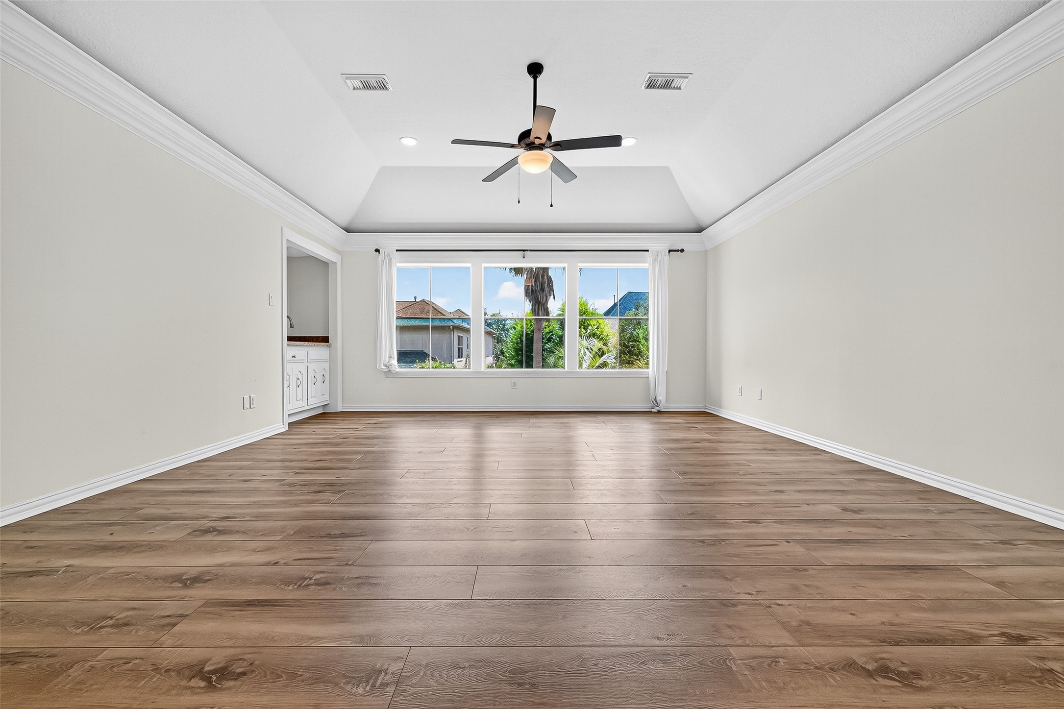 1803 Cottage Landing Lane Houston, TX 77077 - Photo 21 of 50 a view of an empty room with wooden floor and a window