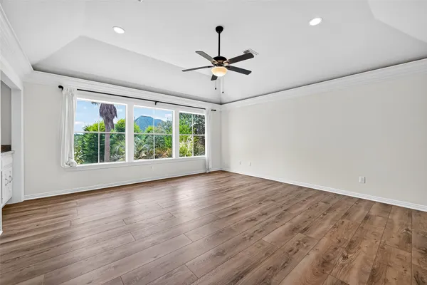 wooden floor in an empty room with a window