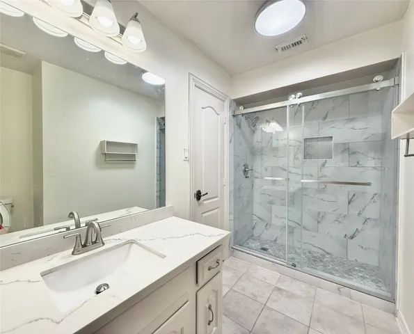 a spacious bathroom with a double vanity sink a mirror and a bathtub