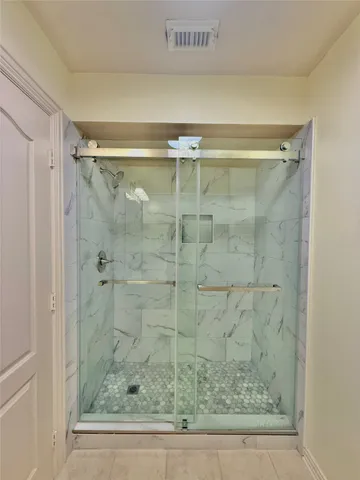 a bathroom with a shower and a sink