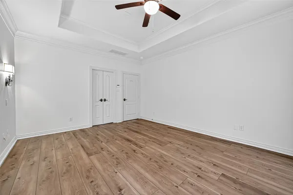 a view of empty room with wooden floor