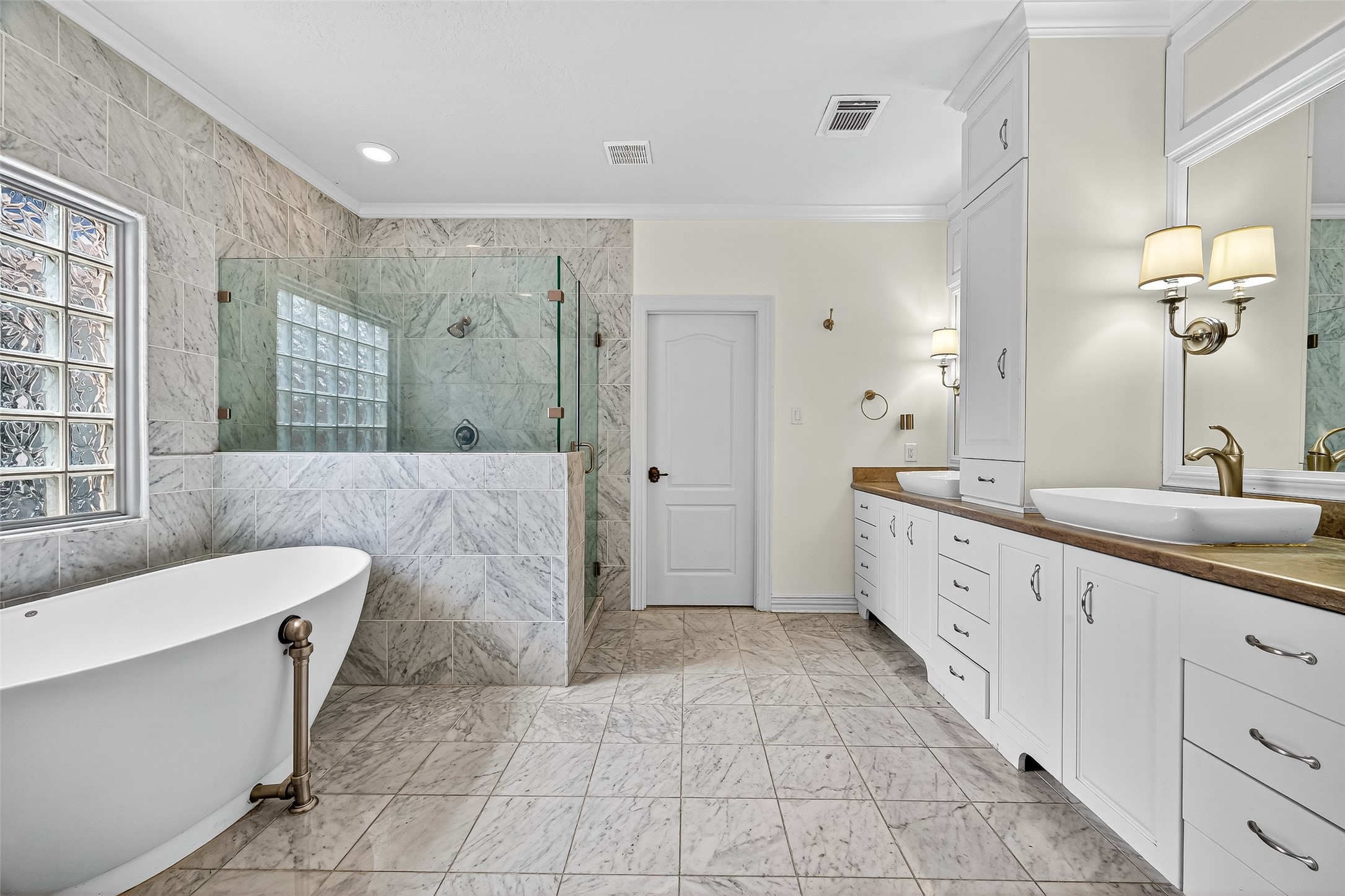 1803 Cottage Landing Lane Houston, TX 77077 - Photo 41 of 50 a spacious bathroom with a double vanity sink a mirror and a bathtub