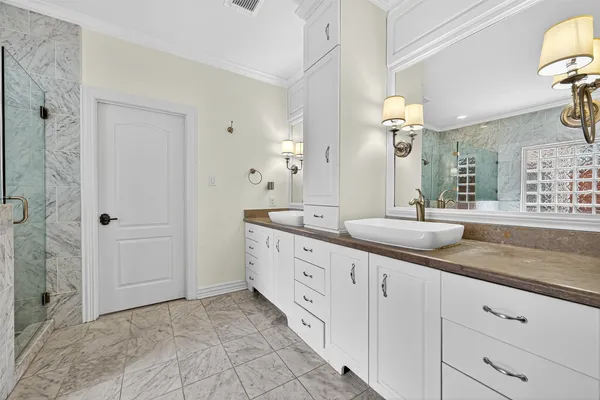 a spacious bathroom with double sink and a mirror