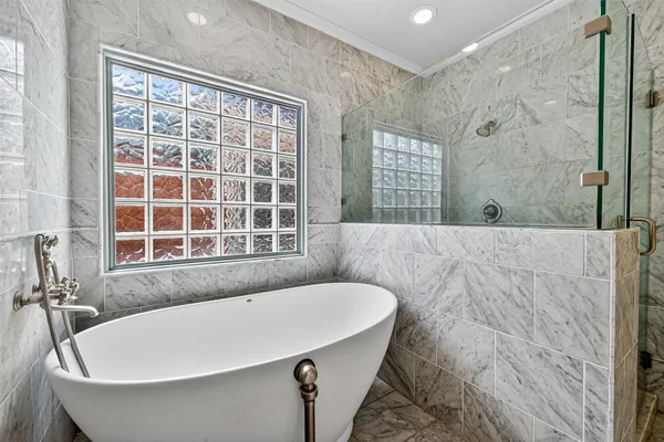 a bathroom with a bathtub and window