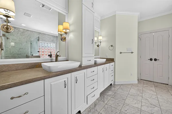 a spacious bathroom with double sink and a mirror