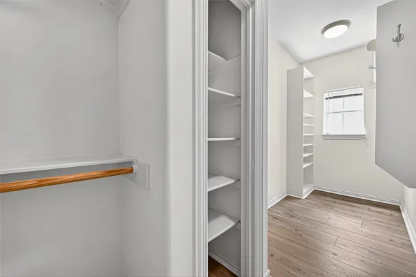 an empty room with wooden floor and closet