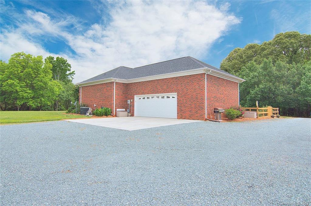 2210 McManus Road Midland, NC 28107 - Photo 3 of 24 a view of the house with a yard and garage