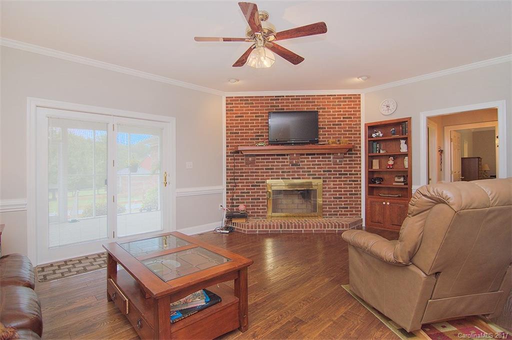 2210 McManus Road Midland, NC 28107 - Photo 8 of 24 a living room with furniture a flat screen tv and a fireplace