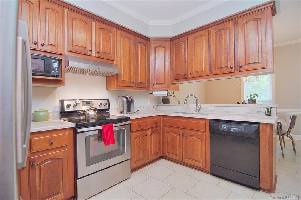 2210 McManus Road Midland, NC 28107 - Photo 10 of 24 a kitchen with stainless steel appliances granite countertop a sink stove and cabinets