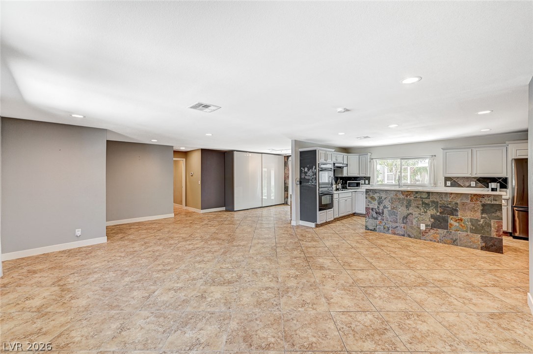 4153 Woodcrest Road Las Vegas, NV 89121 - Photo 54 of 58 An open floorplan seamlessly connects the living space to a well-appointed kitchen, ideal for entertaining.