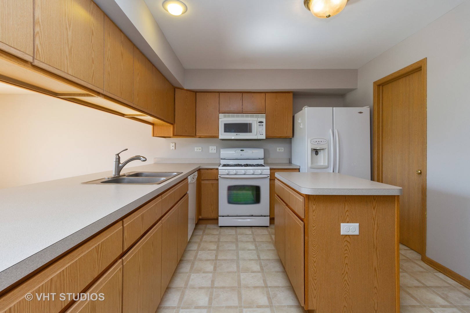 25192 Faraday Road Manhattan, IL 60442 - Photo 4 of 14 a kitchen with stainless steel appliances granite countertop a stove a sink and a refrigerator