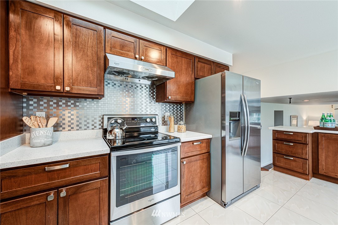 2025 Field Avenue Northeast Renton, WA 98059 - Photo 11 of 23 a kitchen with stainless steel appliances granite countertop a refrigerator and a stove top oven