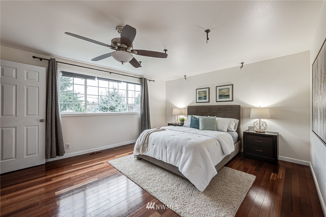 2025 Field Avenue Northeast Renton, WA 98059 - Photo 16 of 23 a bedroom with a large bed and a chandelier