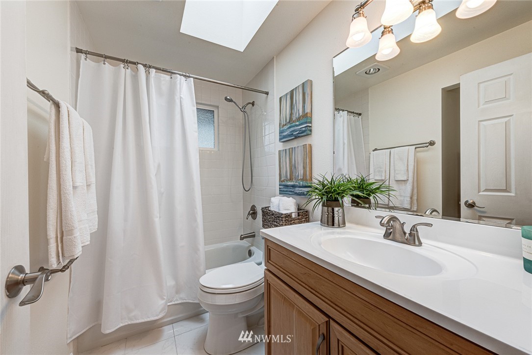 2025 Field Avenue Northeast Renton, WA 98059 - Photo 19 of 23 a bathroom with a sink a toilet and a mirror