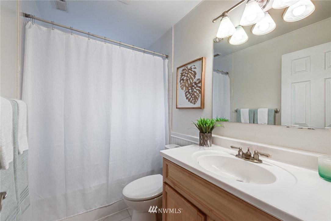 2025 Field Avenue Northeast Renton, WA 98059 - Photo 7 of 23 a bathroom with a granite countertop sink and a mirror