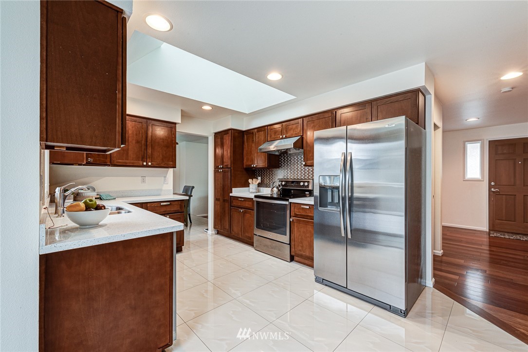 2025 Field Avenue Northeast Renton, WA 98059 - Photo 9 of 23 a kitchen with stainless steel appliances granite countertop a refrigerator a sink and a stove