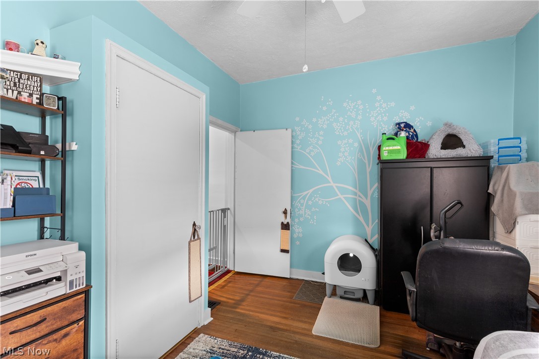 54490 National Road Bridgeport, OH 43912 - Photo 8 of 32 Hardwood flooring, painted walls, ceiling fan, and white trim