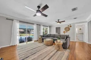 a living room with furniture and a wooden floor