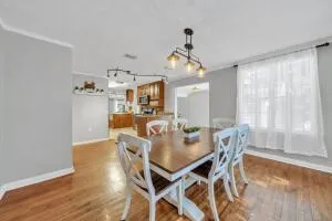 a bed sitting in a spacious bedroom next to a window and a fireplace with wooden floor