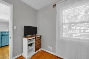 a view of a workspace with furniture and a flat screen tv