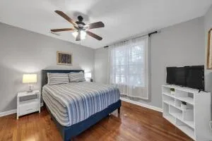 a bedroom with a bed and a flat screen tv