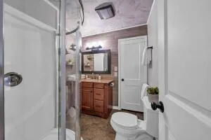 a bathroom with a toilet a sink and shower