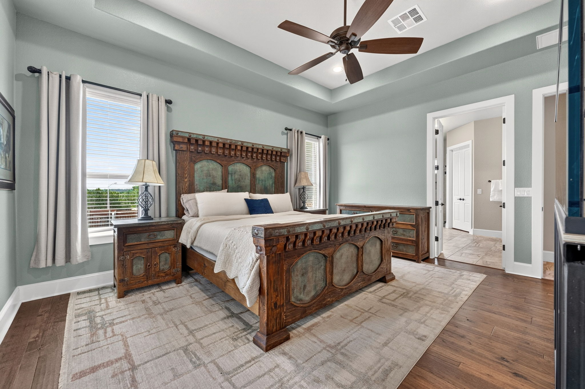 105 Coopers Hill Road Georgetown, TX 78633 - Photo 19 of 40 a bedroom with a large bed and a chandelier