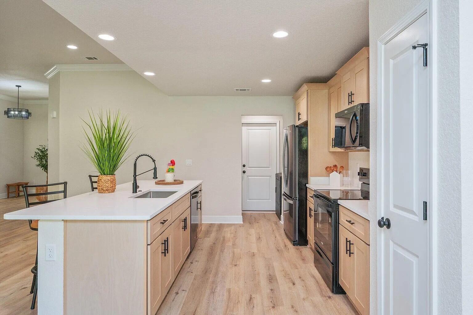 693 Bowers Avenue East Crestview, FL 32539 - Photo 11 of 27 a kitchen with a sink and refrigerator