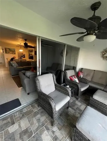 a living room with furniture and a mirror