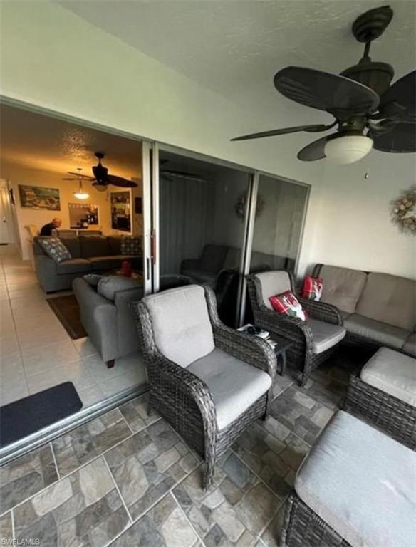 163 Palm Drive, Unit 2878 Naples, FL 34112 - Photo 11 of 14 a living room with furniture and a mirror