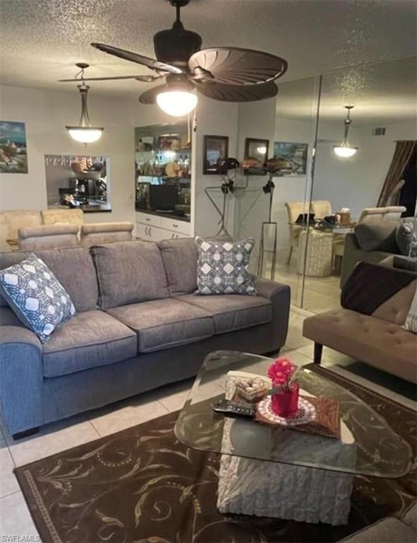 163 Palm Drive, Unit 2878 Naples, FL 34112 - Photo 3 of 14 a living room with furniture and a wooden floor