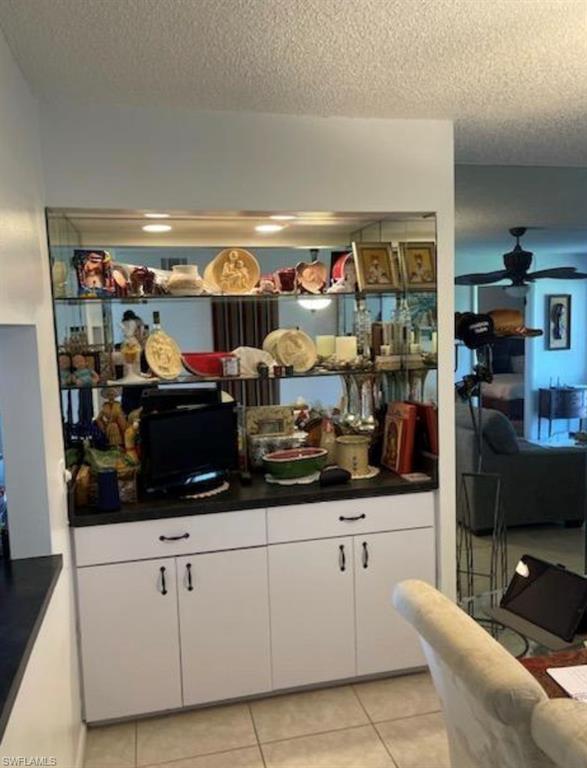 163 Palm Drive, Unit 2878 Naples, FL 34112 - Photo 7 of 14 a kitchen with stainless steel appliances kitchen island granite countertop a sink and cabinets