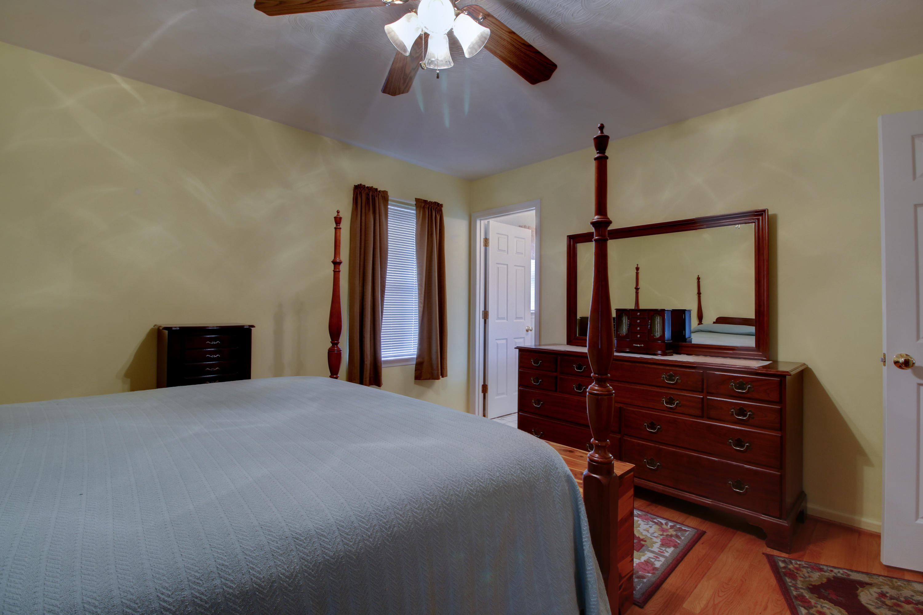 825 Ruddell Road Vinton, VA 24179 - Photo 14 of 25 a bedroom with a bed and a chandelier