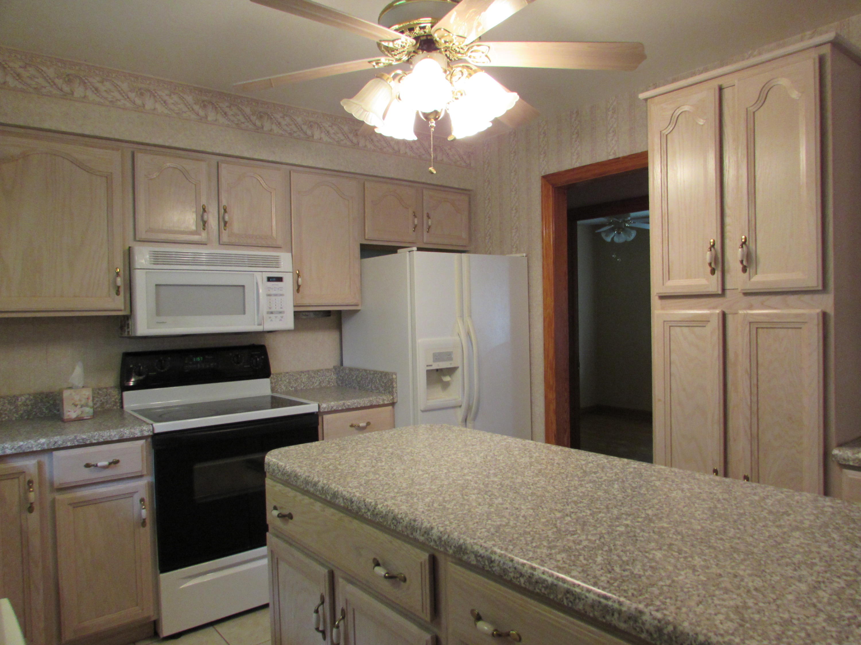 529 Olney Road Vinton, VA 24179 - Photo 2 of 13 a kitchen with a refrigerator sink and cabinets