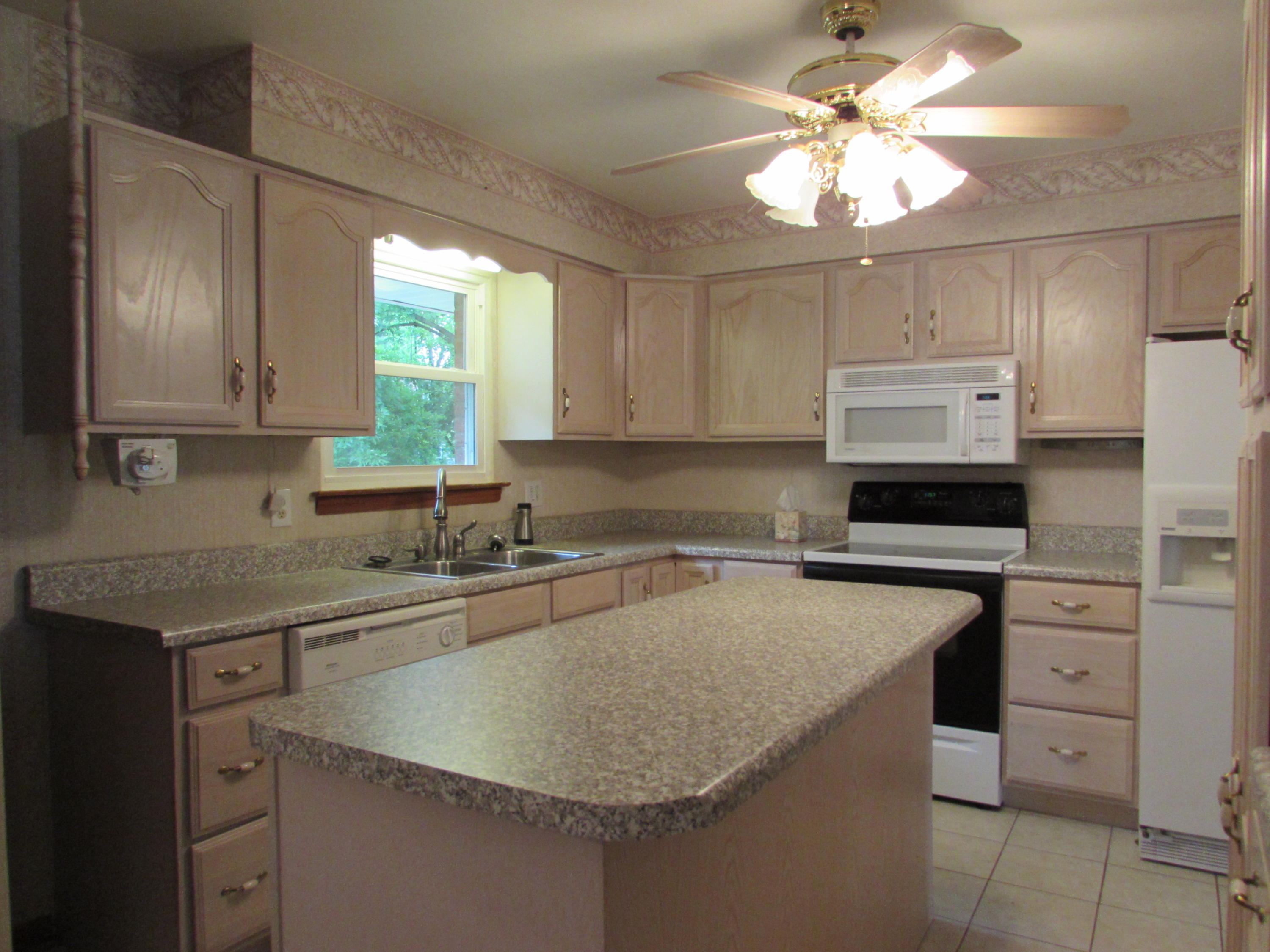 529 Olney Road Vinton, VA 24179 - Photo 3 of 13 a kitchen with a sink a stove and cabinets