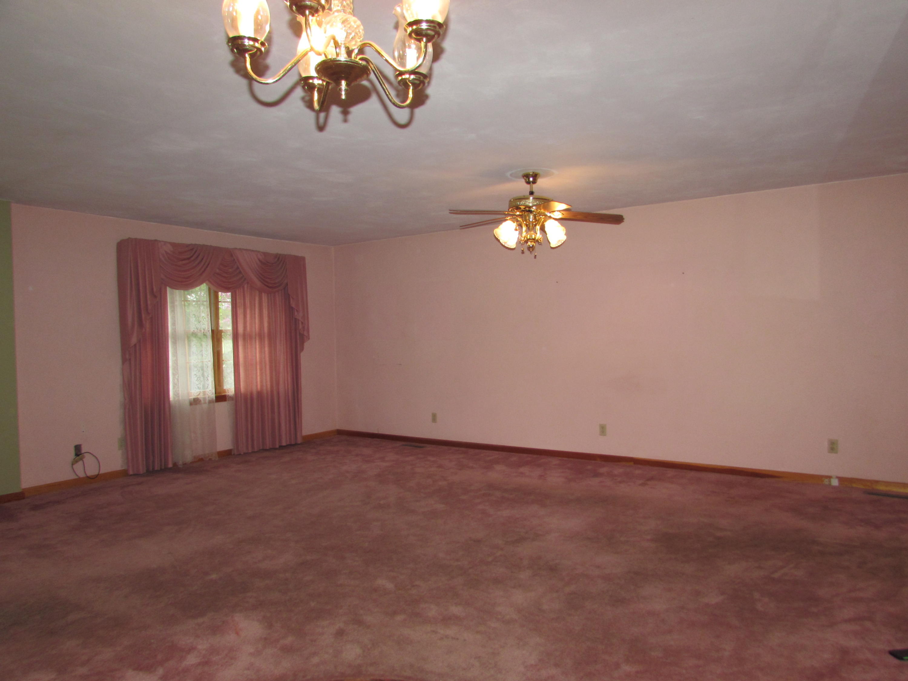 529 Olney Road Vinton, VA 24179 - Photo 5 of 13 a view of an empty room with a chandelier fan