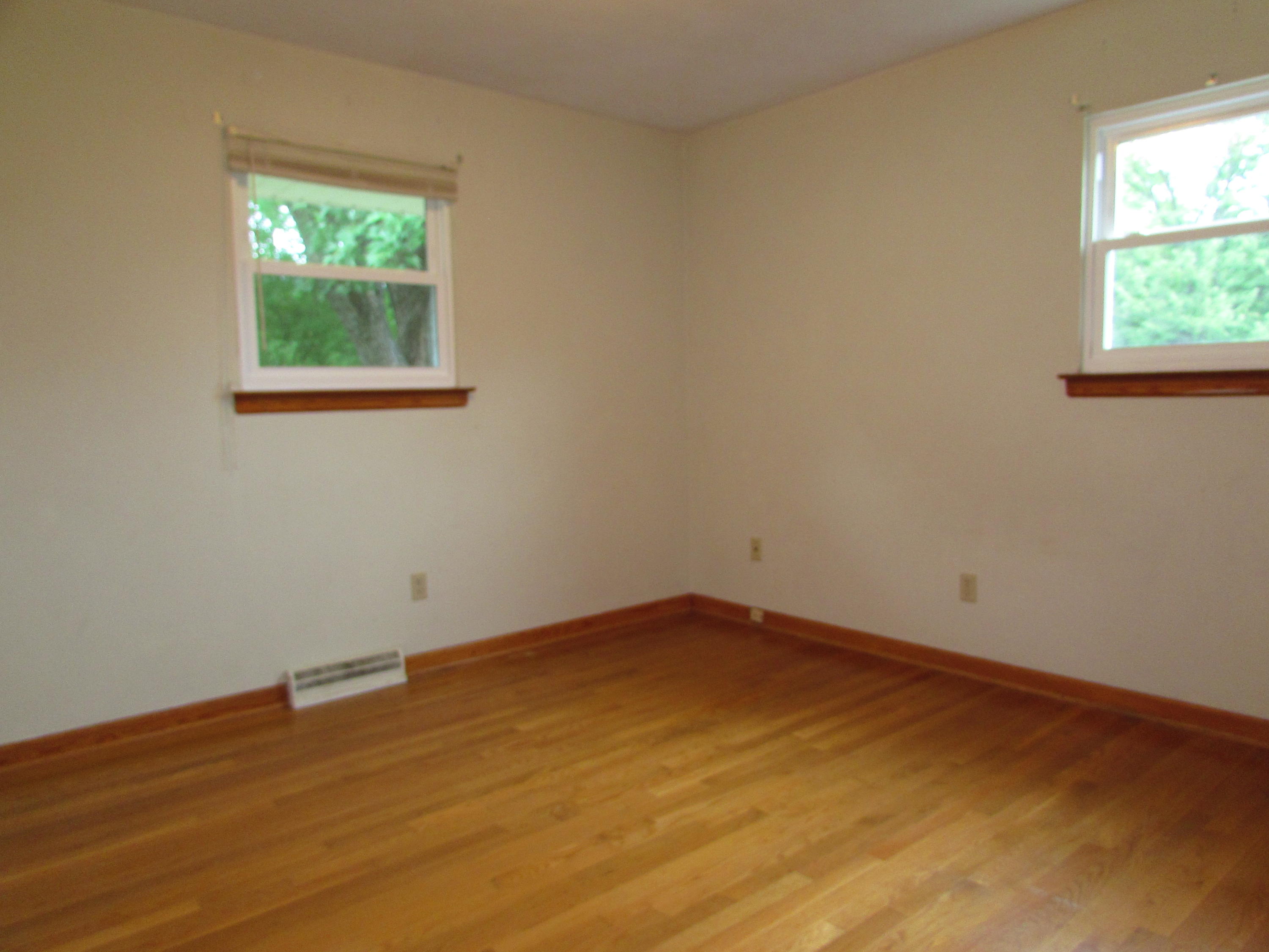 529 Olney Road Vinton, VA 24179 - Photo 8 of 13 an empty room with wooden floor and windows