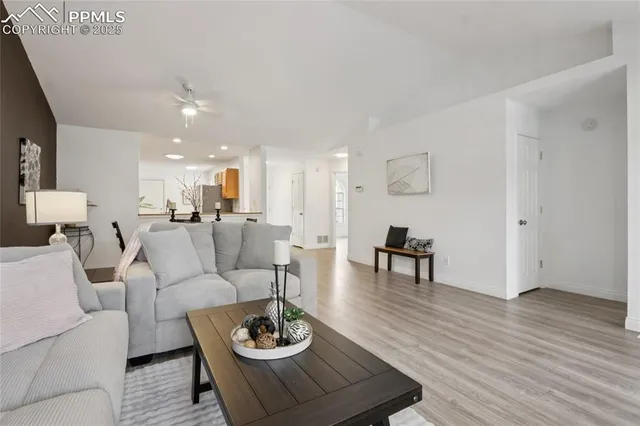 a living room with furniture kitchen view and a dining table