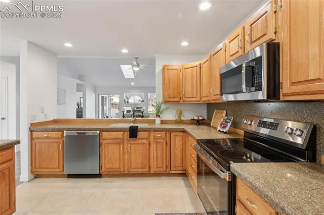 a kitchen with stainless steel appliances granite countertop a stove and a sink