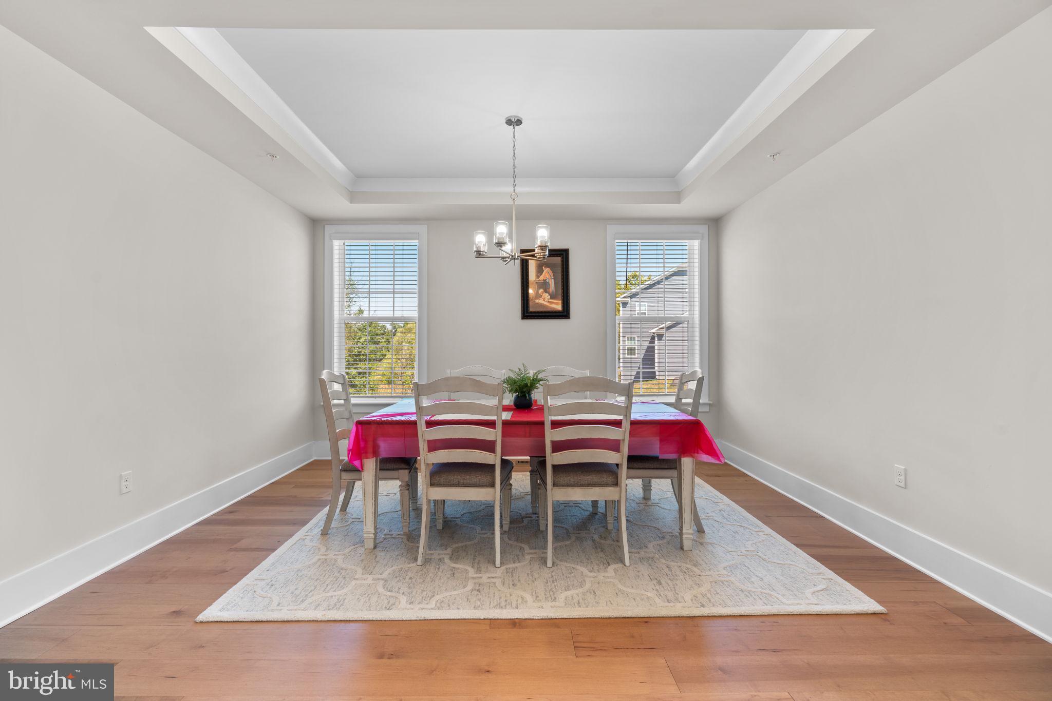 21708 Woodfield Road Gaithersburg, MD 20882 - Photo 15 of 76 a dining room with a wooden table and chairs