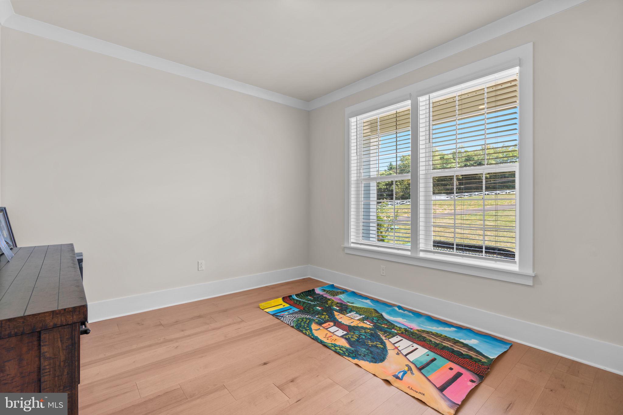 21708 Woodfield Road Gaithersburg, MD 20882 - Photo 17 of 76 a bedroom with a bed and a window