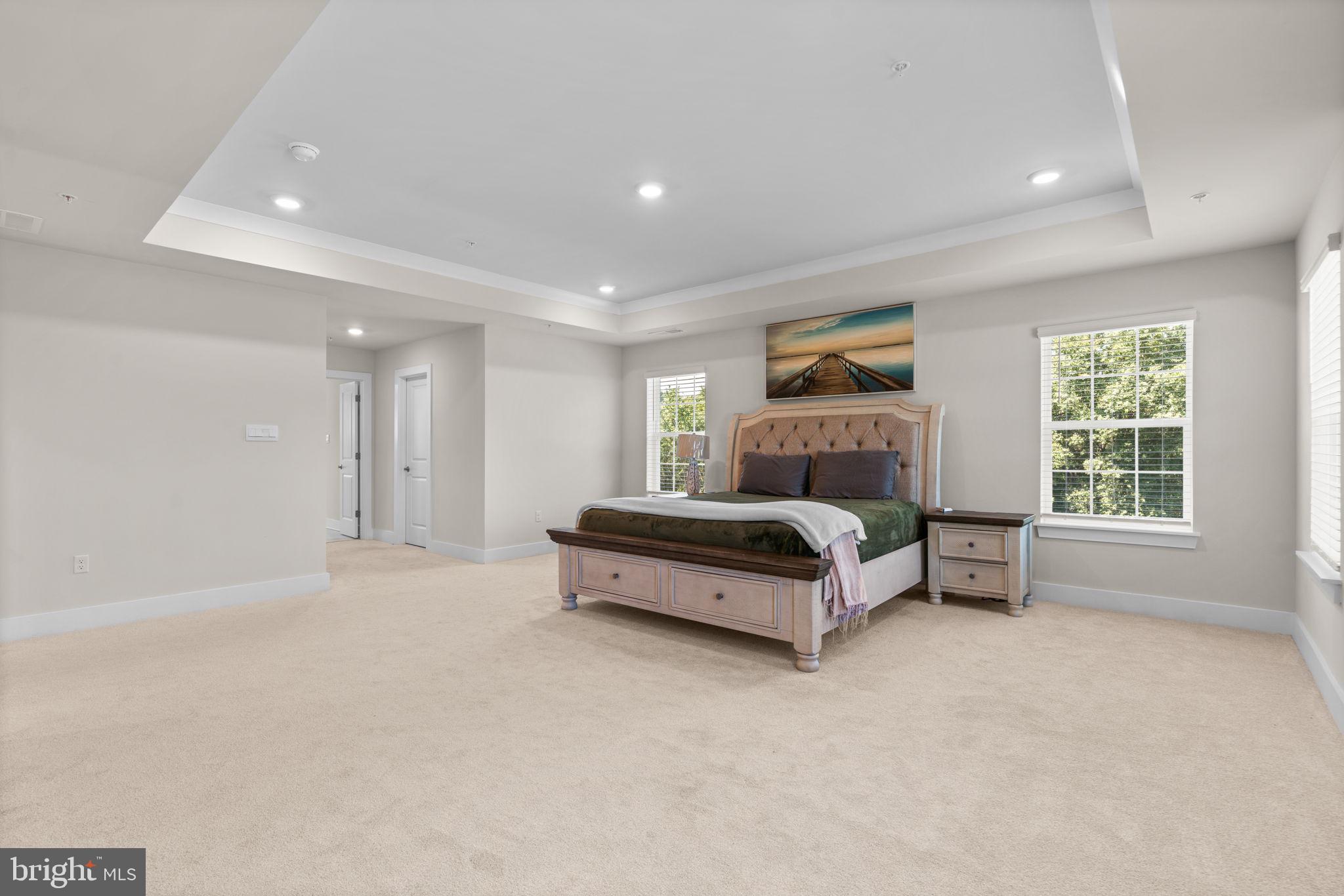 21708 Woodfield Road Gaithersburg, MD 20882 - Photo 25 of 76 a spacious bedroom with a bed and a cabinets